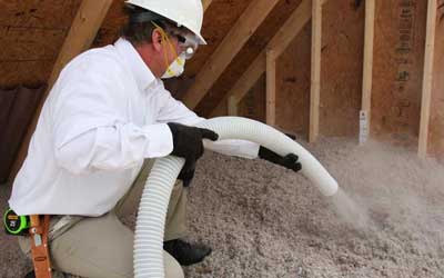 insulation being installed in a home attic
