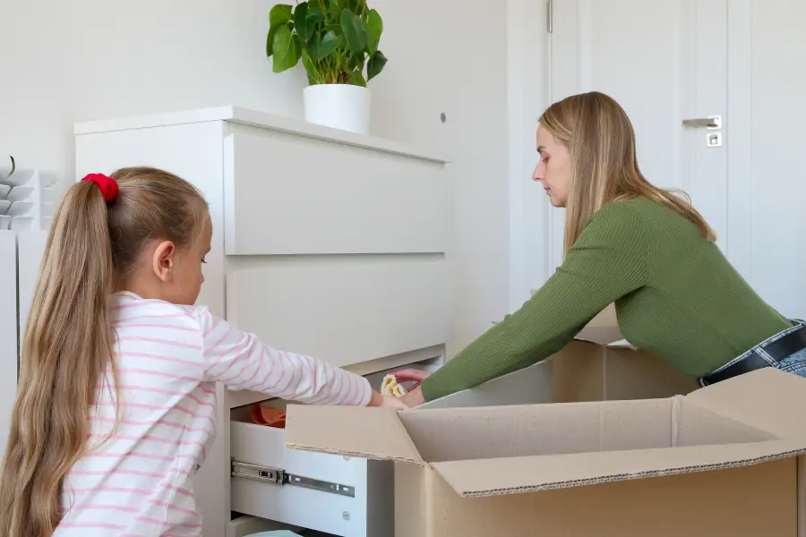 Packing up a bedroom dresser in preparation for bed bug treatment