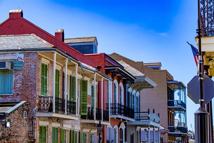 Strip of apartments with balconies on a street - Keep pests away form your home with Ja-Roy in Louisiana