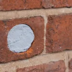 Flexi armor rodent control applied to a hole in a brick wall